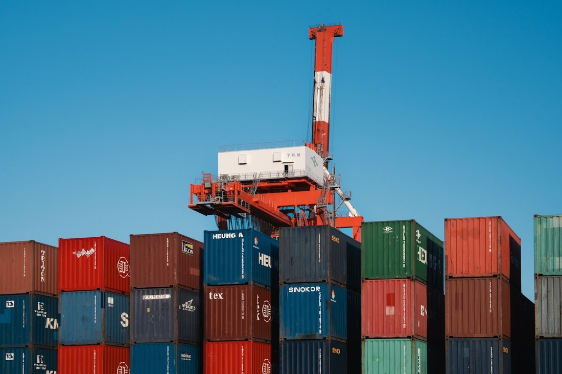 Open yard with rows of stacked shipping containers and clear access lanes at Mundra